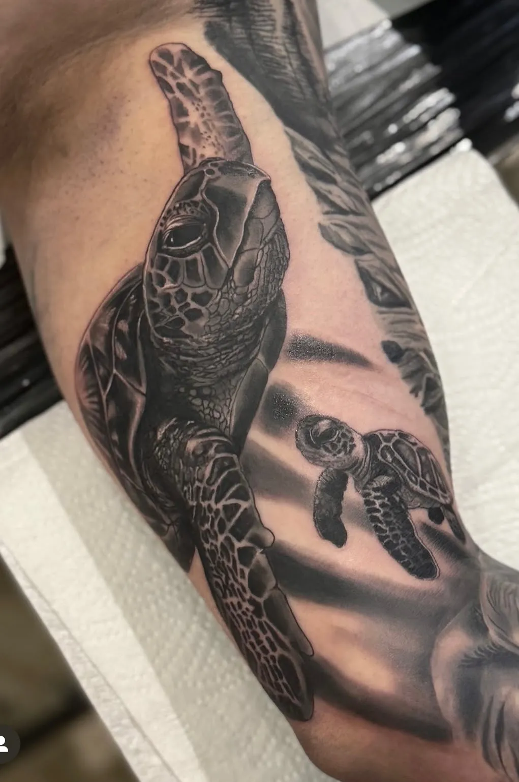 Sea turtle motion tattoo in black and grey realism